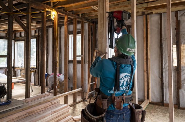 volunteer framing a wall
