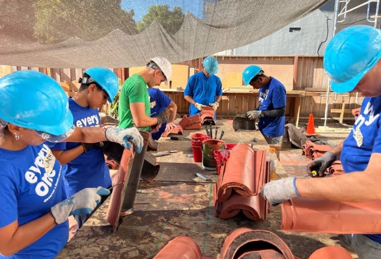 Volunteers working on the roof of a home.