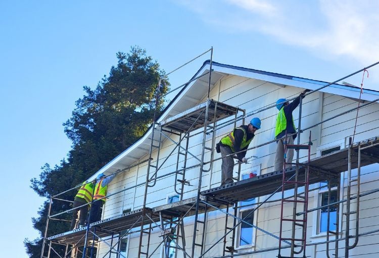 volunteers on scaffolding painting at Sequoia Grove