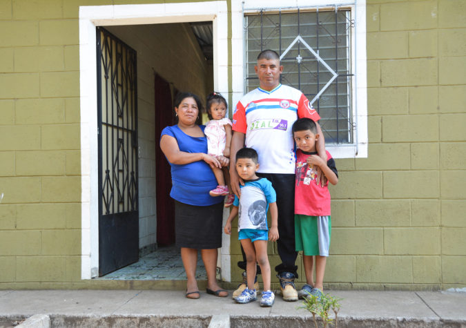 Family in front of home in El Salvador