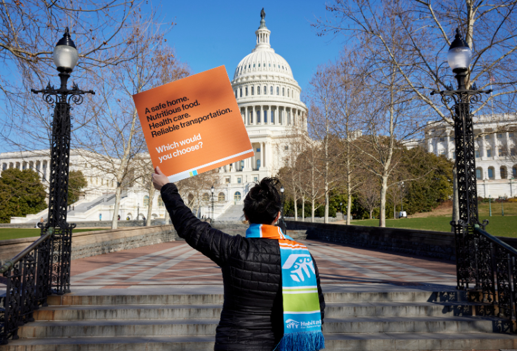 Habitat Advocate holding up a sign in front of US Capitol