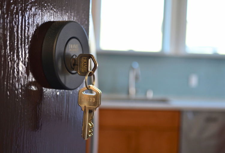 Key in the front door of a home at 4th and Reed