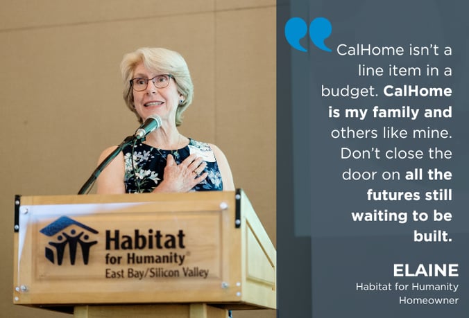 Habitat Homeowner Elaine stands at a Habitat podium
