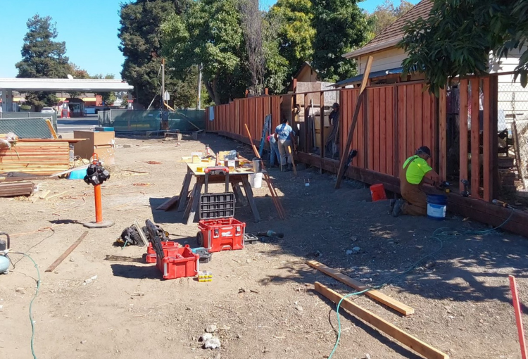 Volunteers building a fence on a Habitat Construction Site