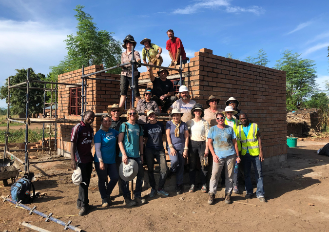 volunteers in front of Habitat home in Malawi