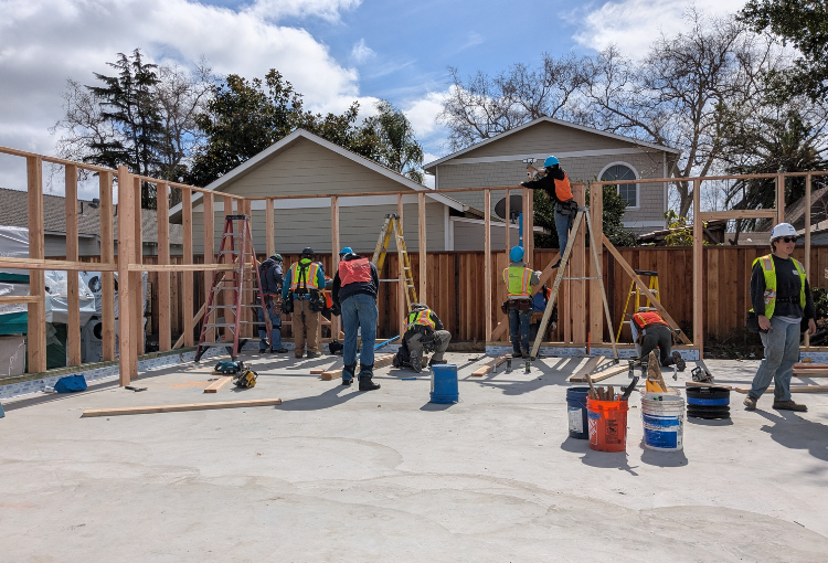 Volunteers framing walls at a Habitat construction site