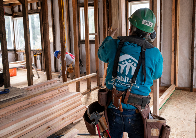 volunteer framing a home