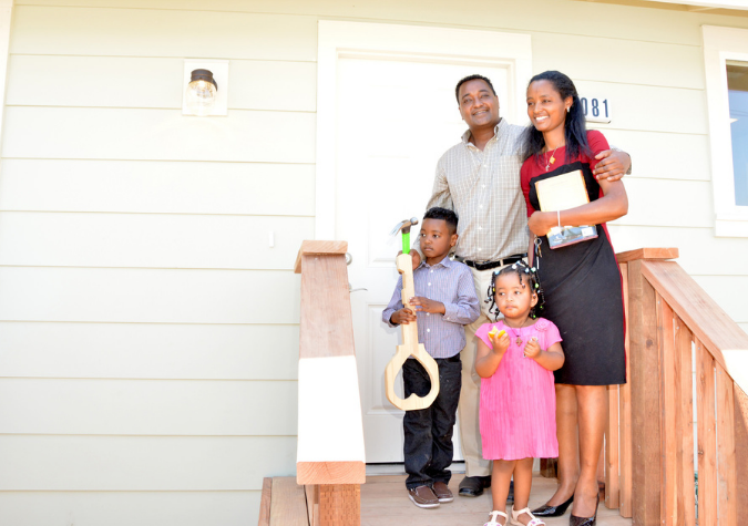 Family in front of home