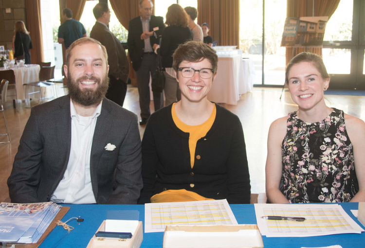 Volunteers sitting at a registration table